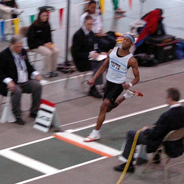 Fred Jones hits the board in the long jump.