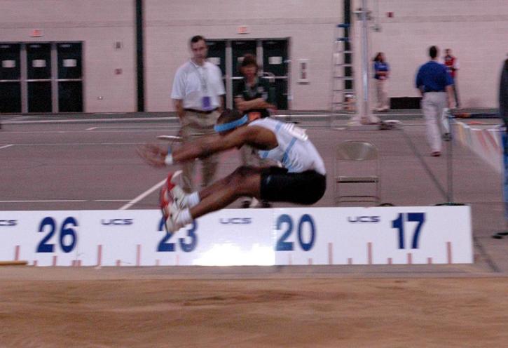 Fred Jones puts the finishing touches on an excellent long jump.