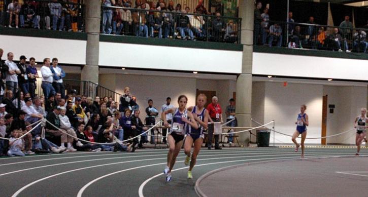 Carter Hamill (Amherst) passes Caroline Cretti (Williams) to take the lead in the 5000.