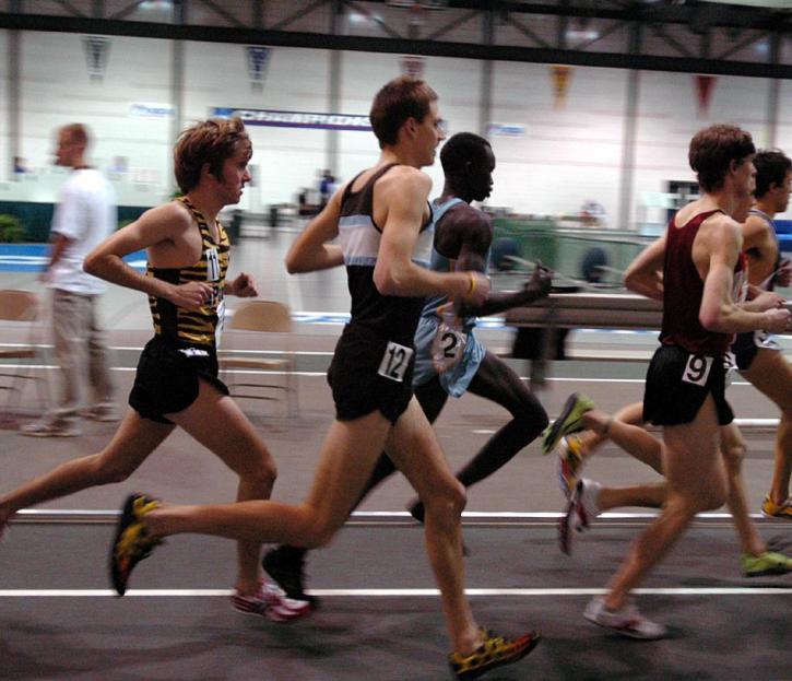 Nate Brigham runs in traffic in the early laps of the 5000.