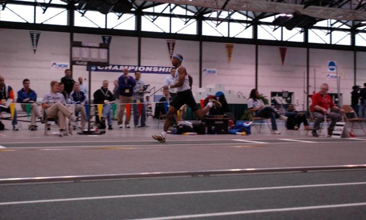 Fred Jones in middle of a triple jump.