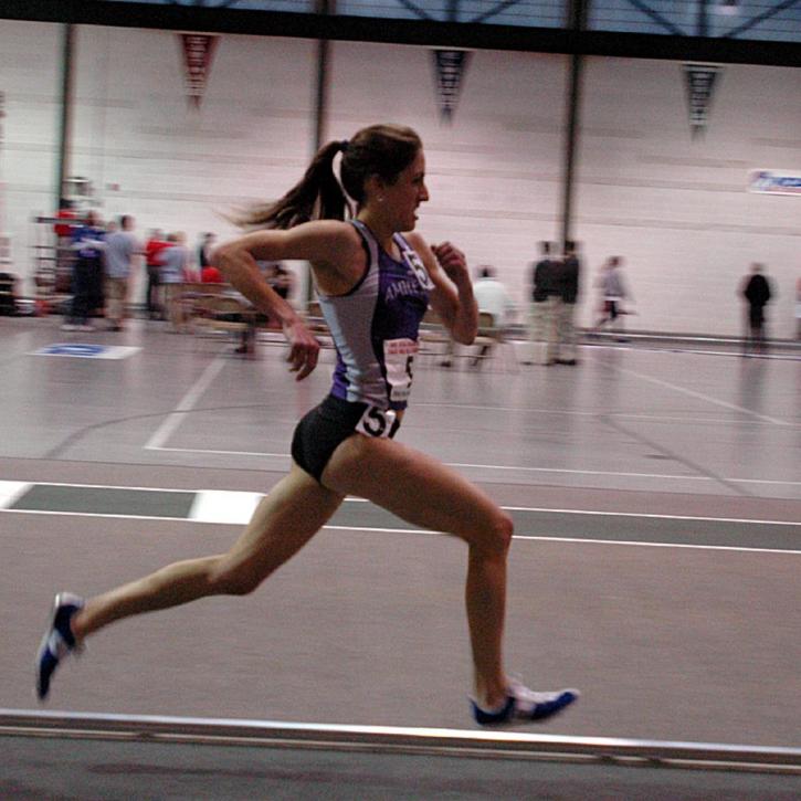 Carter Hamill of Amherst kicks to win her third indoor 5000 title.