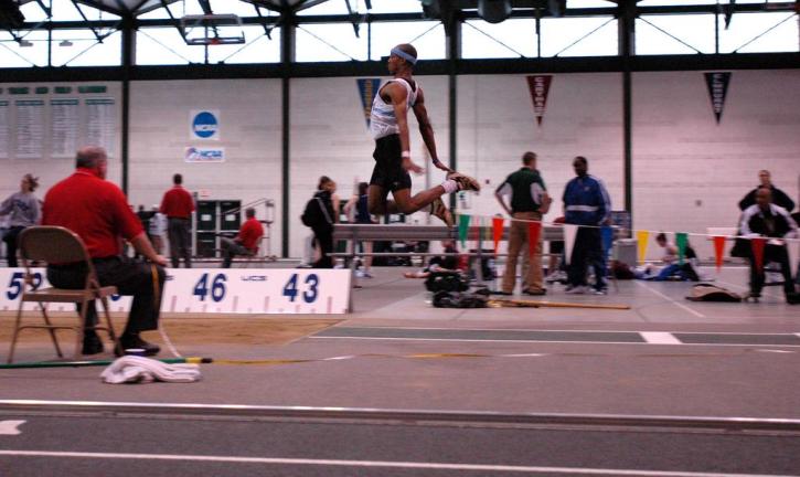 Fred Jones in the final stage of a triple jump.