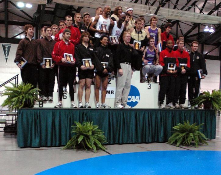 Aaron Kaye and Pat Mahoney pose on the podium with the top 8 teams from the DMR.