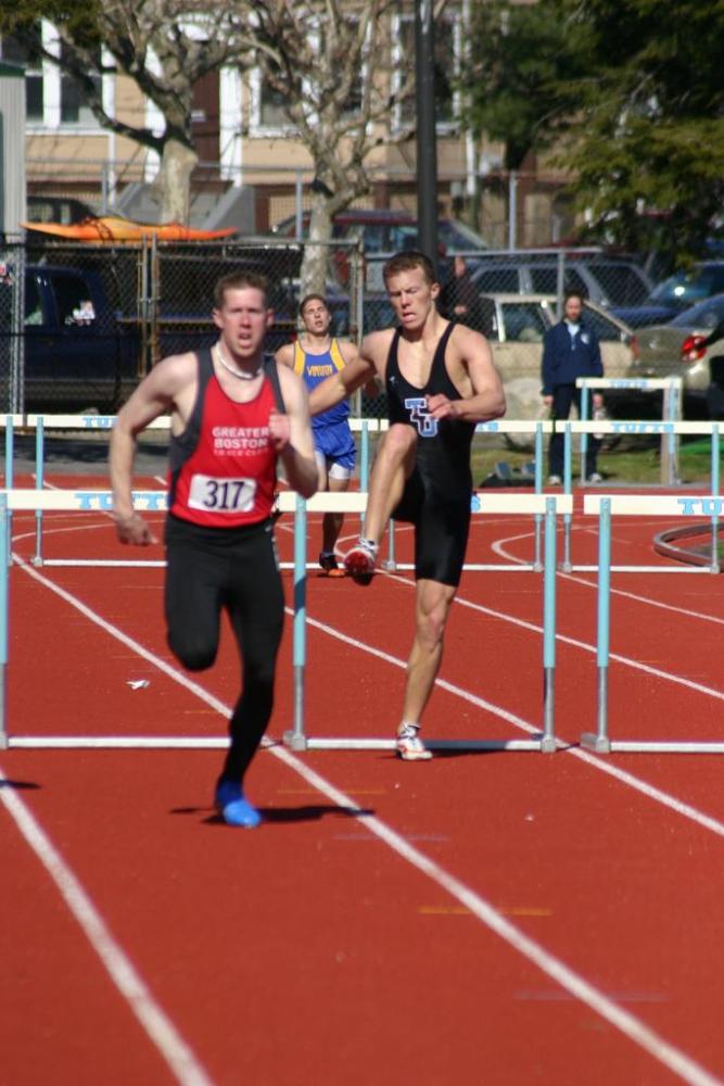 Trevor Williams clears the final hurdle in the 400 IH.