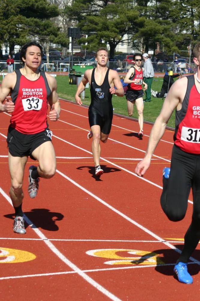 Trevor Williams finishes up his performance in the 400IH, surrounded by GBTC runners.