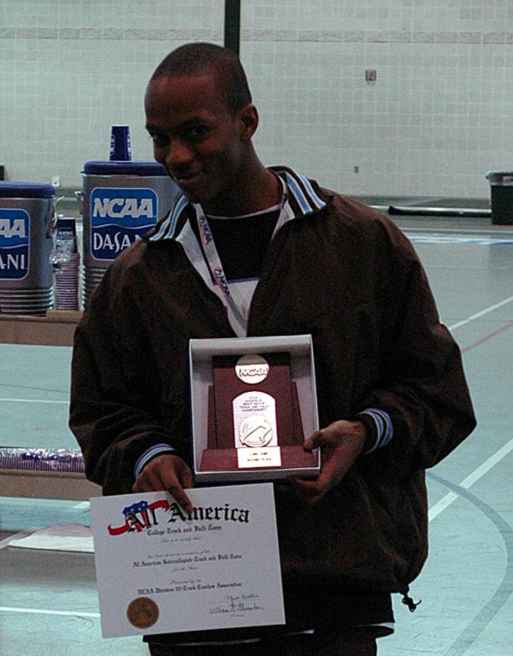 Sophomore Fred Jones proudly displays his third All-American certificate.  He earned this one with a second place finish in the long jump.  