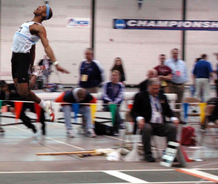 Fred Jones distances himself from the ground in the long jump.