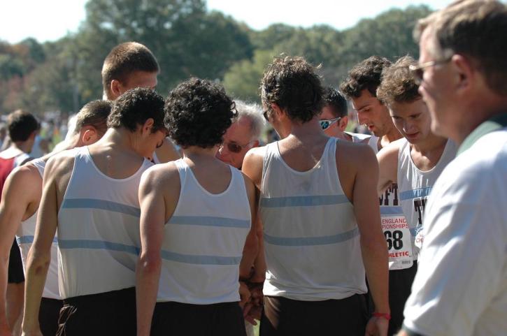 Coach Putnam gives his words to Tufts runners at All New Englands