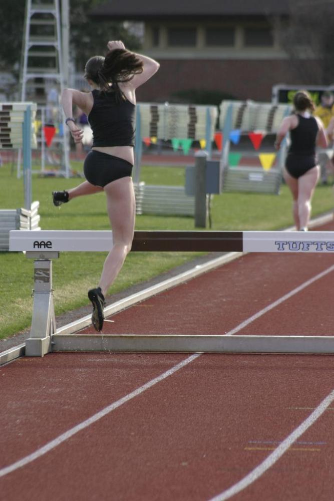 Katy O'Brien uses her unconventional hurdle form in the steeplechase.