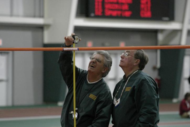 Officials doing their thing at high jump.