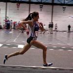 Carter Hamill of Amherst kicks to win her third indoor 5000 title.