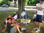 the guys relax, watching the wiffle ball game